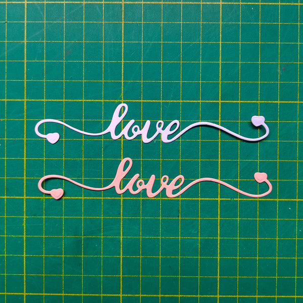 Decorative cutout letters spelling 'love' on a grid background