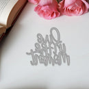 Decorative cutout with 'I love you' on a white surface with pink roses and an open book.