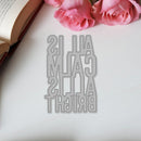Metallic bookmark with text on a white surface with pink roses