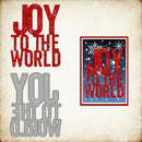 Decorative metal cutout with 'Joy to the World' text on a textured background