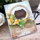 Handmade card with floral design and text on a wooden surface