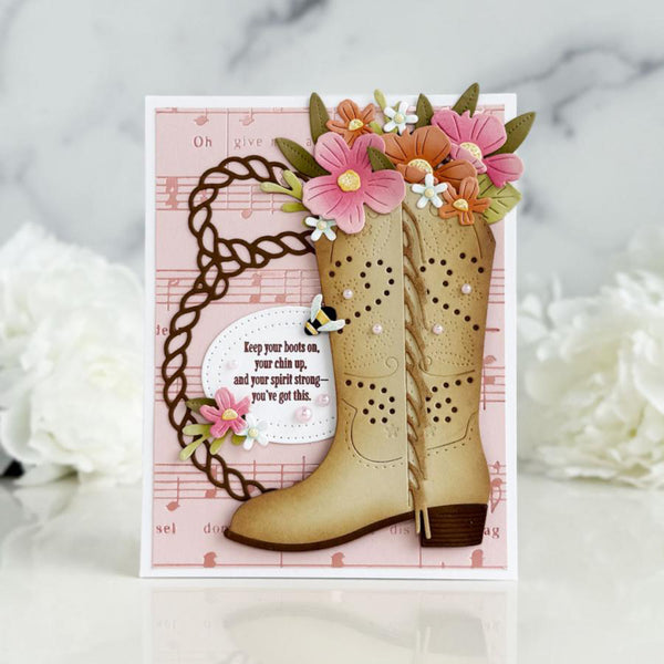 Card with decorative boots and flowers on a pink background