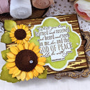 Decorative card with sunflowers and a peace quote on a textured surface