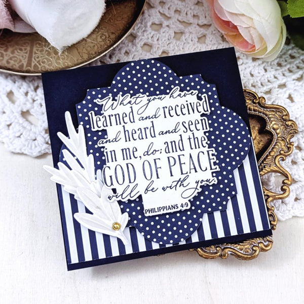 Navy blue card with white text and design elements on a decorative surface.