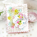 Decorative card with floral design and text on a white surface with decorative elements.