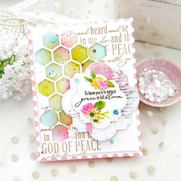 Decorative card with floral design and text on a white surface with decorative elements.