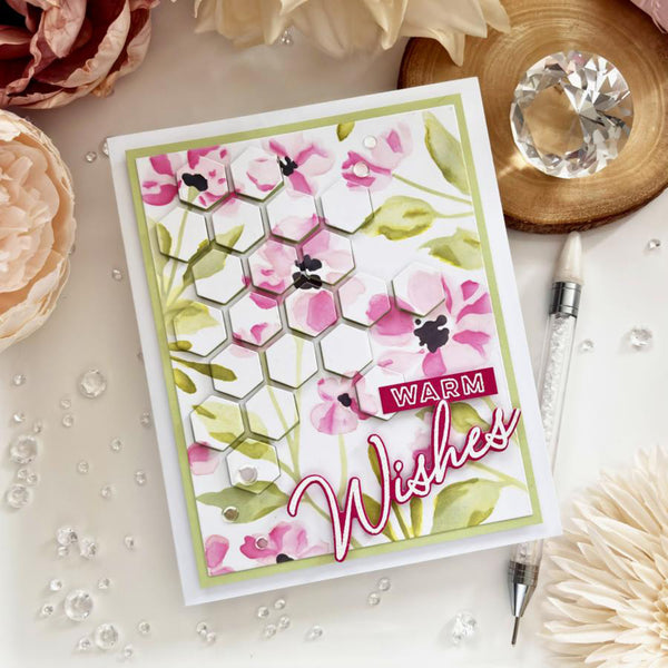 Greeting card with floral design and 'Warm Wishes' text on a decorative surface.