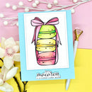 Card with colorful macaron illustration and 'be a macaron in a cookie cutter world' text on a pink and yellow background.
