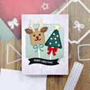 Christmas card with reindeer and tree design on a wooden surface