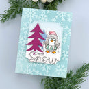 Christmas card with penguin and tree design on a snowflake patterned background