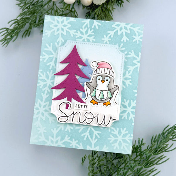Christmas card with penguin and tree design on a snowflake patterned background