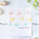 Card with colorful shell and star stickers on a white background with seashells and greenery.