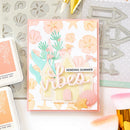 Card with 'Sending Summer Vibes' text and beach-themed design on a crafting surface with tools.