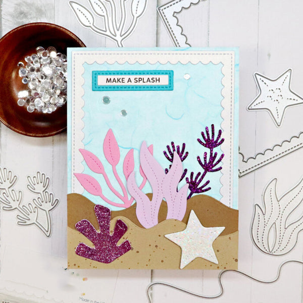 Card with ocean-themed design featuring pink and purple coral and a starfish, surrounded by crafting materials.