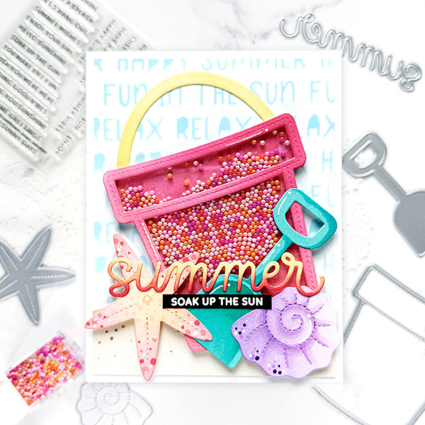 Colorful sand bucket with summer-themed text and decorative elements on a white background