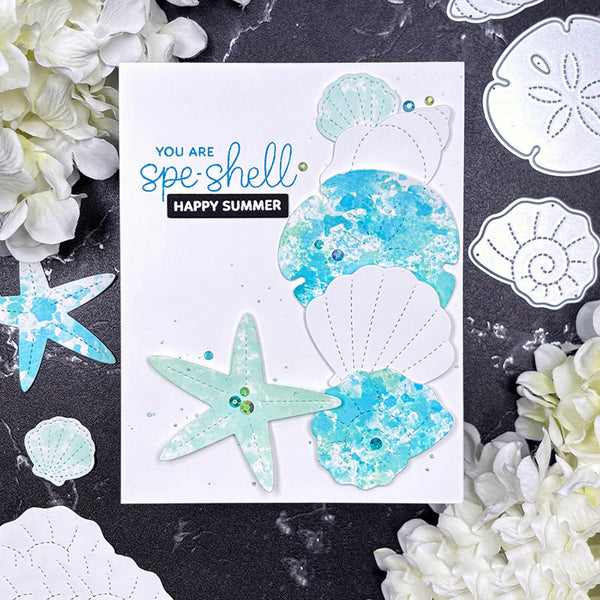 Card with shell and starfish designs and 'Happy Summer' text, surrounded by decorative elements on a dark background.