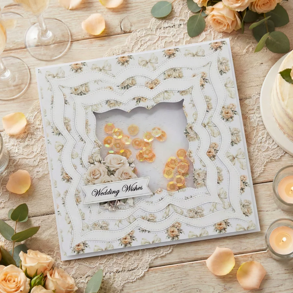 Decorative wedding card with floral design on a wooden table with flowers and candles.