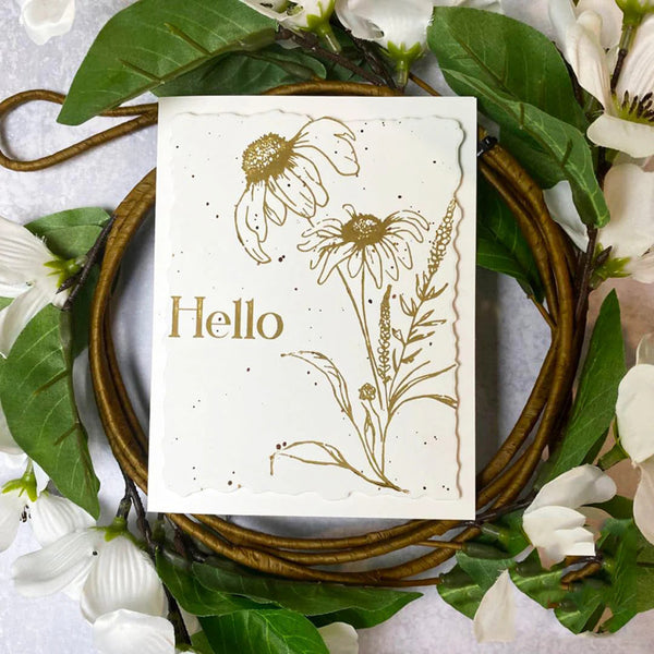 Card with floral designs and 'Hello' text on a wreath with green leaves and white flowers.