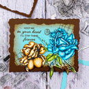 Decorative card with blue and orange flowers and text on a textured surface.