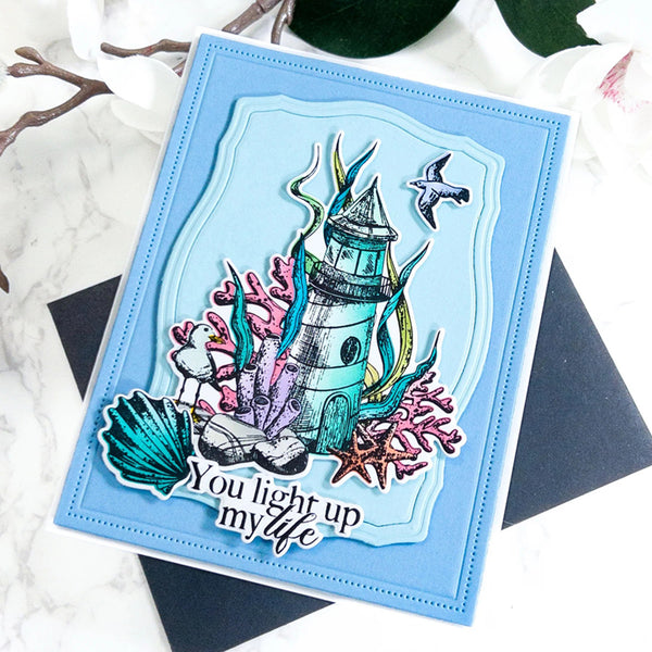 Card with a lighthouse design and text 'You light up my life' on a light blue background.