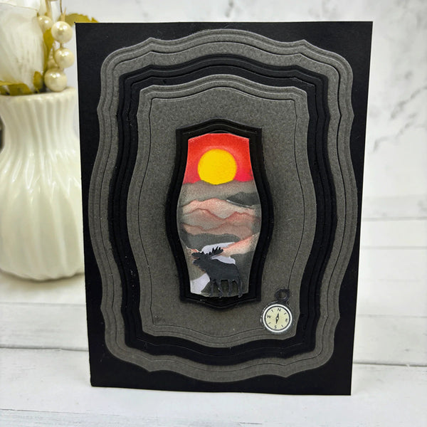 Artistic depiction of a landscape with a sunset and layered black frame.