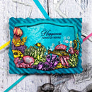 Colorful coral reef design with text on a textured surface