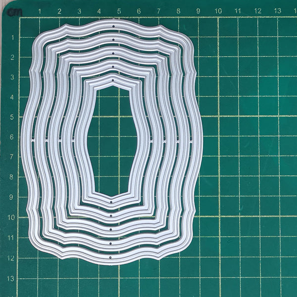 Set of layered white cutouts on a green grid background