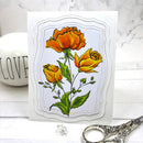 Card with orange roses on a marble surface with scissors and a 'LOVE' container.