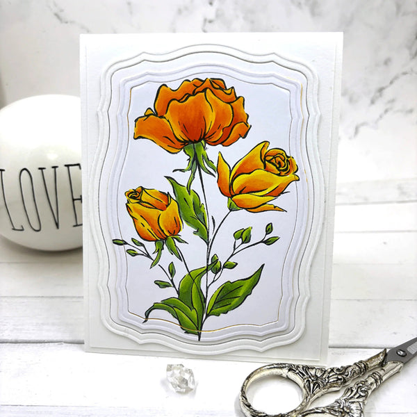 Card with orange roses on a marble surface with scissors and a 'LOVE' container.