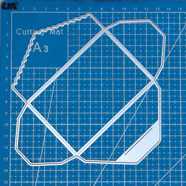 Clear geometric cutting template on a blue grid cutting mat