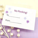 Greeting card with 'No Peeking!' text on a decorative background with snowflakes.