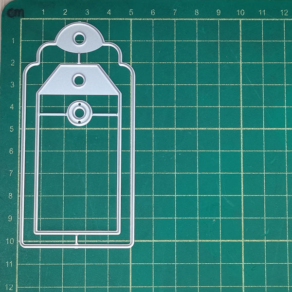 Clear plastic tag cutter on a grid background
