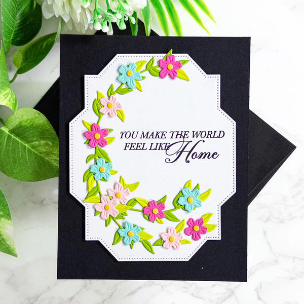 Greeting card with floral design and text 'You make the world feel like home' on a black background.