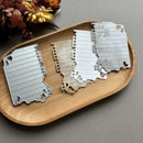 Metallic state-shaped cutouts on a wooden tray with a neutral background