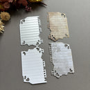 Metal die cut shapes on a gray surface with floral decorations.