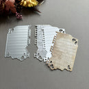 Metal cutting dies shaped like a state on a gray surface with flowers in the corner.