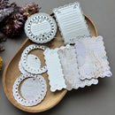 Decorative paper cutouts on a wooden tray with a gray background