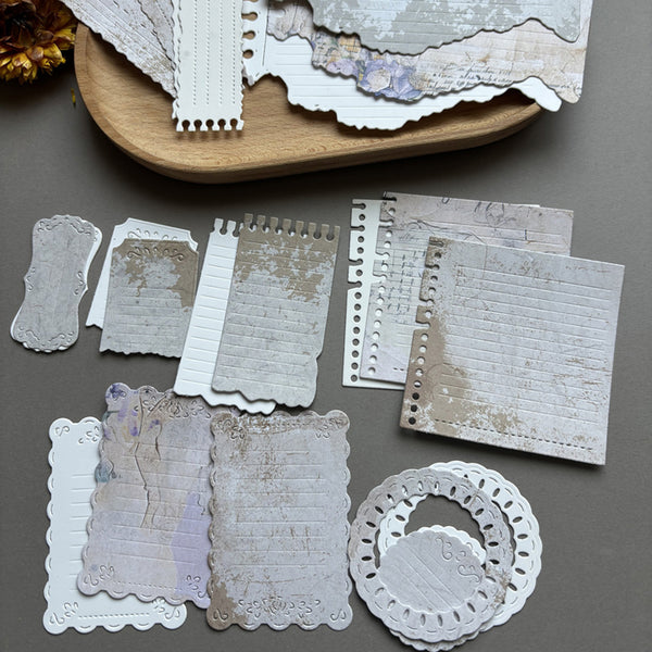 Collection of decorative paper pieces on a gray surface