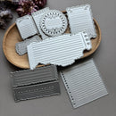 Set of metal dies with various shapes on a wooden board against a gray background