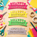 Colorful 'Happy Birthday' cutouts on a wooden surface with scissors and paper.