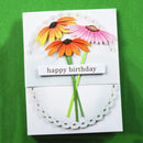 Handmade birthday card with colorful flowers and 'happy birthday' text on a green background