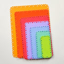 Set of colorful die-cut paper shapes on a light gray background