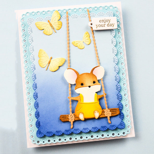 Card with a cute illustration of a mouse on a swing, surrounded by butterflies and text 'enjoy your day'.
