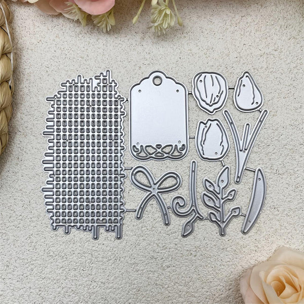 Set of metal dies with various shapes on a textured surface with flowers and roses.