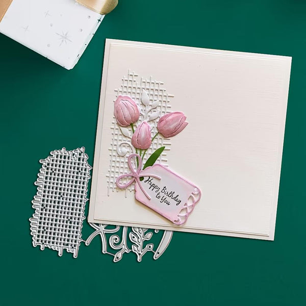Card with pink tulips and a tag, accompanied by metal cutting dies on a green background