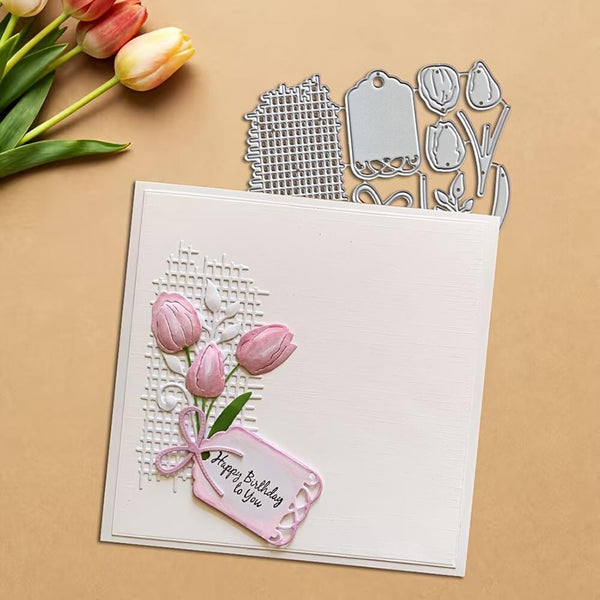 Card with pink tulips and a tag, surrounded by tulip-themed crafting tools on a beige background.