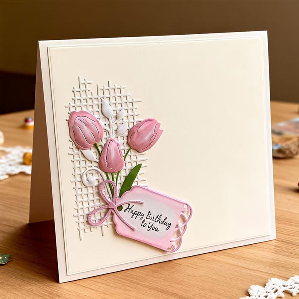 Greeting card with pink tulips and 'Happy Birthday To You' tag on a wooden surface