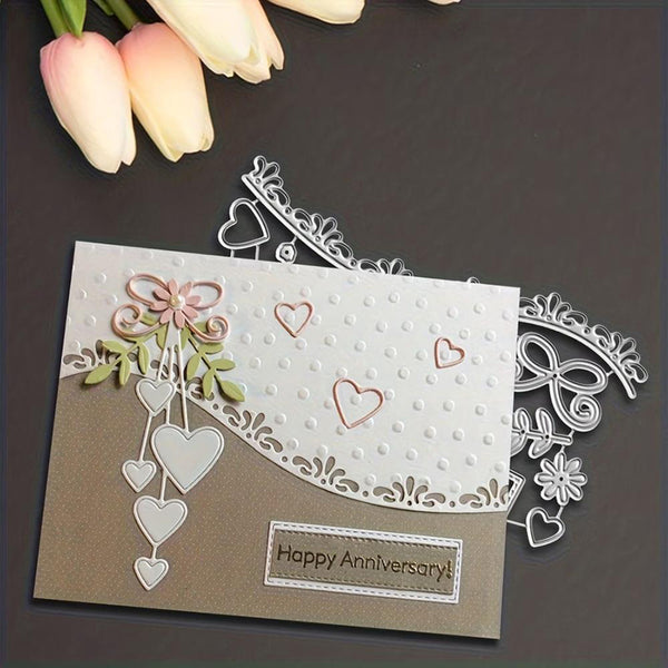 Handmade card with decorative elements and 'Happy Anniversary!' message, accompanied by tulips on a dark surface.