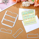 Metal cutting dies, paper with decorative cutouts, and flowers on a wooden surface