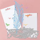 Metallic feather-shaped cutting dies on a pink background